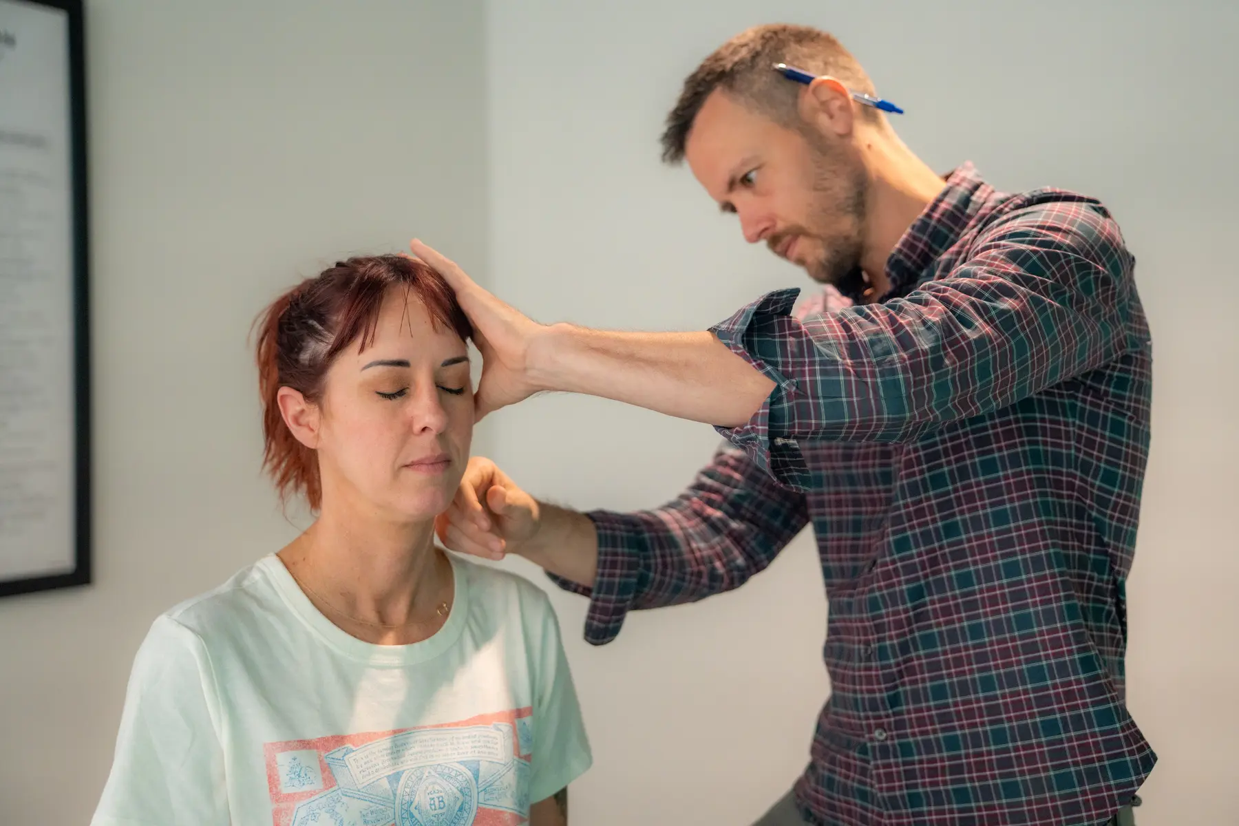 Dr. Michael Moss evaluating a patient with neck pain